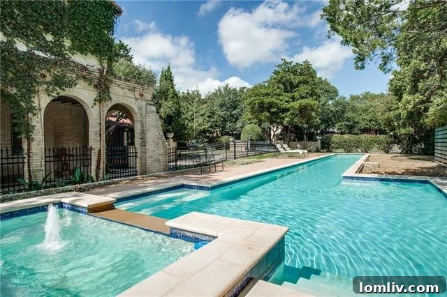 A refreshing swimming pool in the backyard, a modern addition that perfectly complements the historic home, essential for Dallas summers.