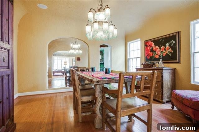 The elegant dining room featuring an original mirrored arch, reflecting natural light and enhancing the room's spaciousness and historical charm.