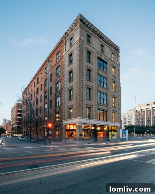 A captivating vertical shot highlighting the grand scale and meticulously restored details of the Historic Purse Building's interior, showcasing high ceilings, architectural depth, and exposed brickwork for a truly unique aesthetic.