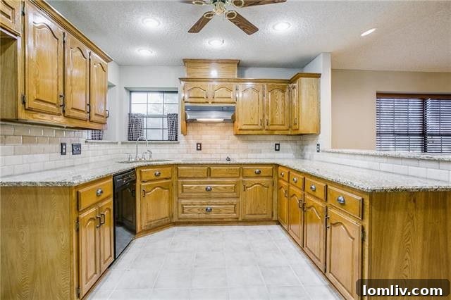 Functional kitchen with granite counters and breakfast bar