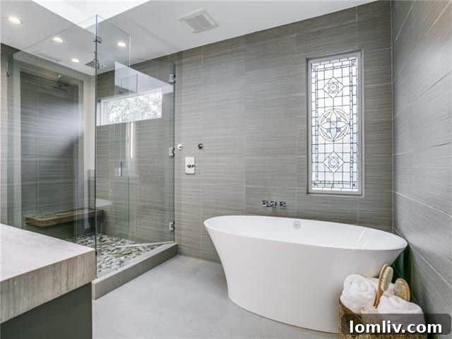 Lakewood Tudor's Modern Renaissance 14 Luxurious bathroom with modern fixtures and spacious shower