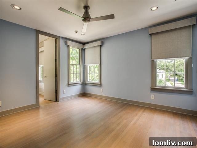 Lakewood Tudor's Modern Renaissance 18 Stylish guest bedroom with ample natural light