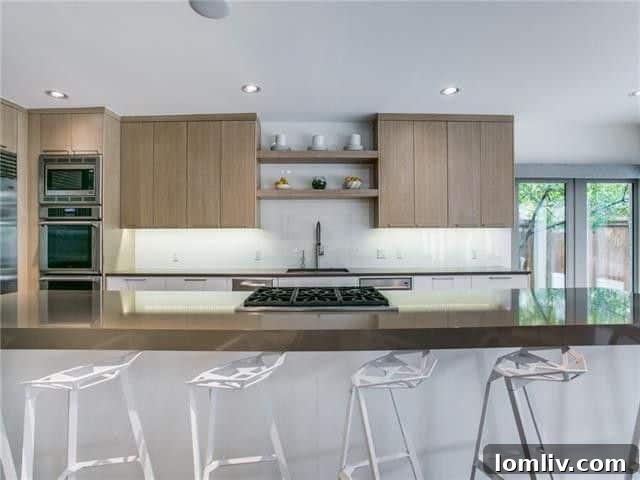 Lakewood Tudor's Modern Renaissance 10 Gourmet kitchen with large island and high-end appliances