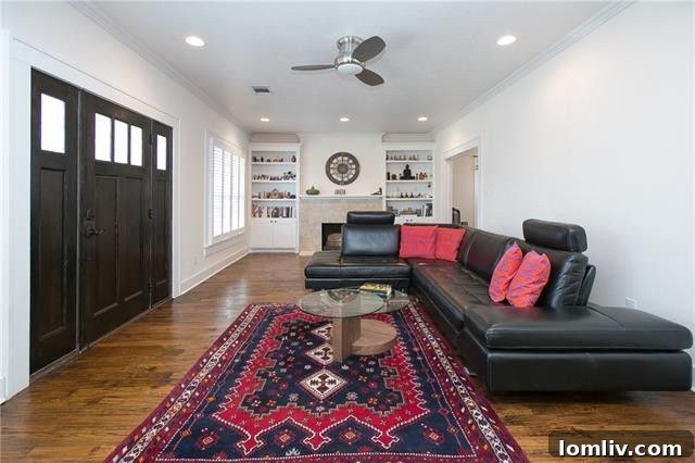 Spacious living room with hand-scraped hardwood floors and abundant natural light.