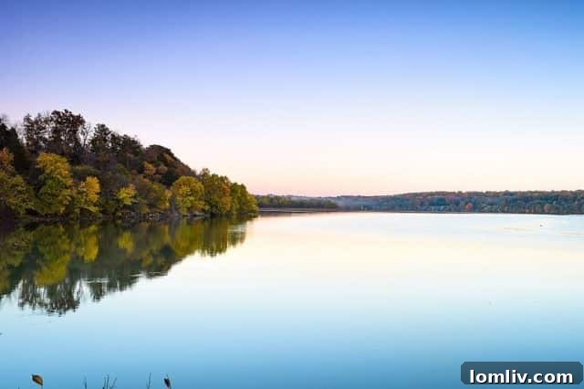 Serene sunset over Lake Springfield, Missouri, with a tranquil reflection on the water