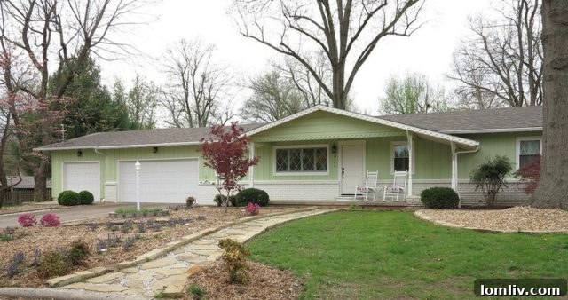 A charming, well-maintained single-family home in Springfield, Missouri, with a manicured lawn
