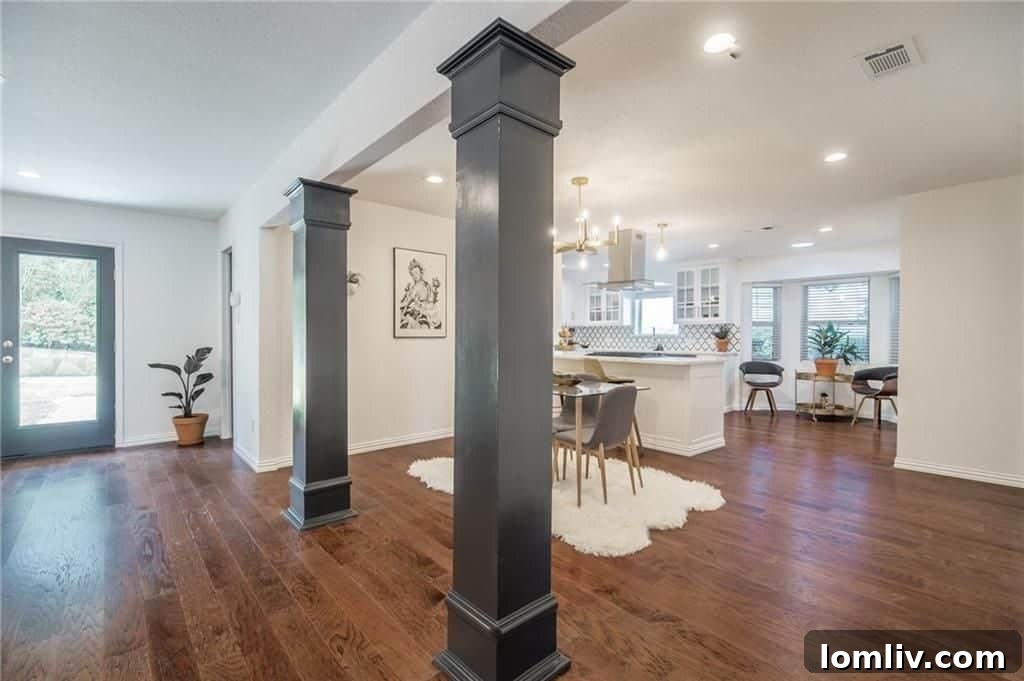 Spacious living room leading to dining area in Fort Worth ranch house