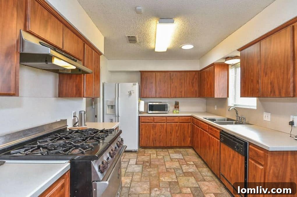 Before renovation kitchen with outdated cabinets and flooring