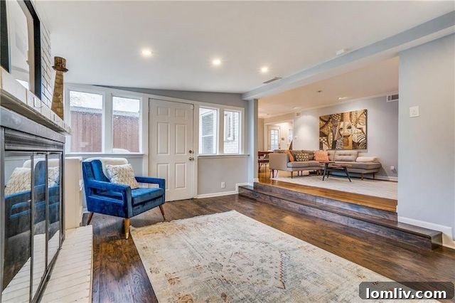 Cozy den area with floor-to-ceiling brick fireplace in East Dallas home