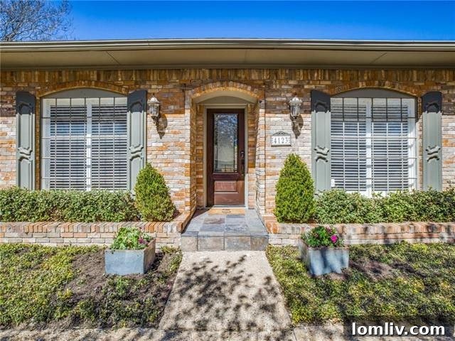Exterior front view of the Glen Meadows Ranch home at 4123 High Summit Drive, featuring lush landscaping and classic architecture.