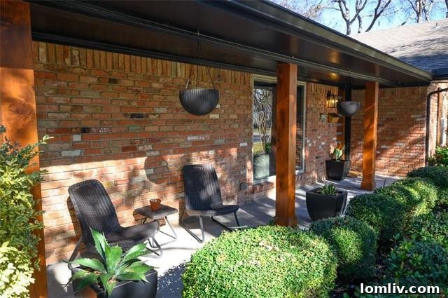 Exterior view of 10355 Cary Back Circle, showcasing its well-maintained single-story design and inviting entrance with mature trees.