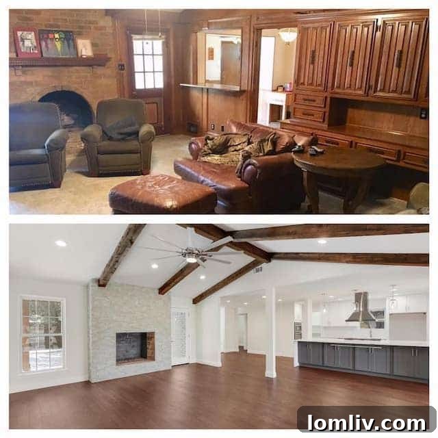 Spacious living room with exposed beams and stacked stone fireplace after renovation