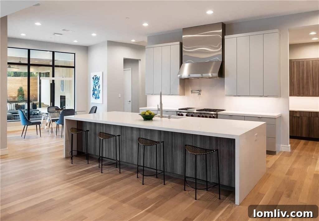 Modern kitchen featuring a large island, granite countertops, and efficient appliances