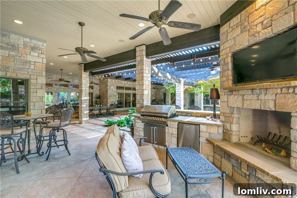 Luxurious outdoor kitchen with built-in grill, seating, and entertainment area