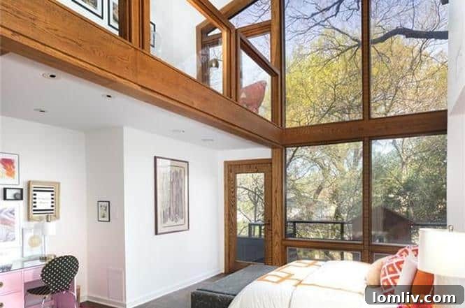 Bright second bedroom with floor-to-ceiling windows and balcony access