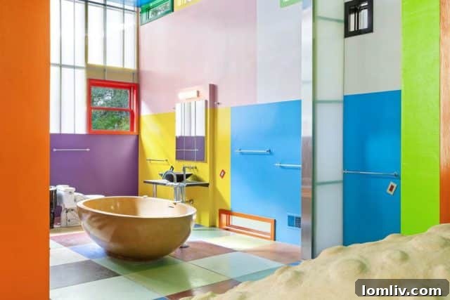 A wide interior shot of the Bioscleave House, showing the large open space, multi-level flooring, and vibrant colors, perhaps hinting at a communal or living area where occupants are constantly engaged with their environment.