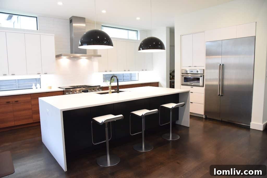 The open floor plan of Chef Nikky's kitchen with a grand island and Caesarstone waterfall countertop.