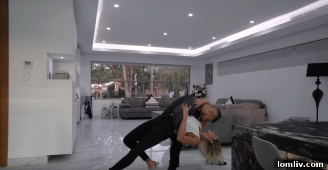 Animated GIF of a man jumping onto a kitchen counter in a real estate video