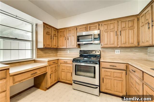 Updated kitchen showcasing practically new stainless steel appliances, modern countertops, and bright cabinetry