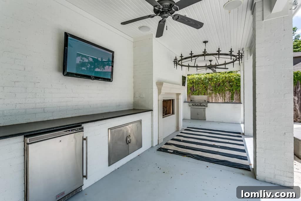 New outdoor kitchen with fireplace and grill at 2417 Boyd Avenue