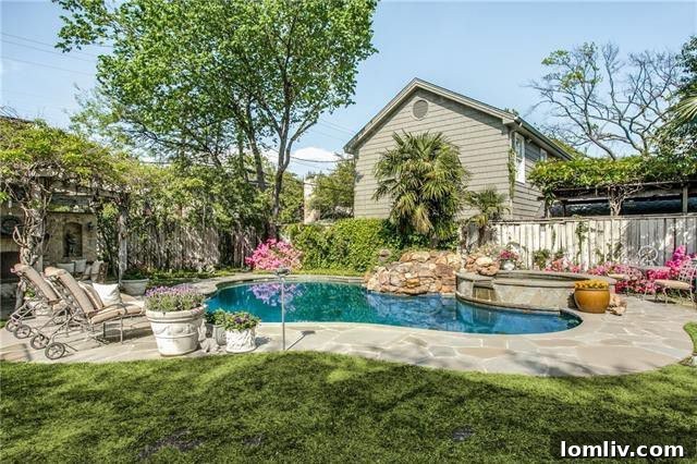 Inviting Outdoor Patio with Fireplace and Pool in Dallas Home