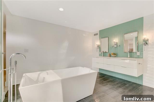 Modern master bathroom with floating trapezoidal tub and polished concrete