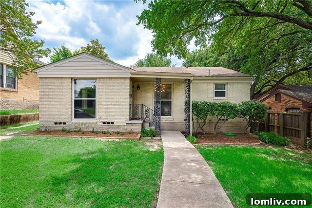 Front exterior view of a charming 1946 Minimal Traditional home in Dells District, Oak Cliff, featuring a well-maintained lawn and classic architecture