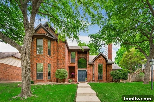 Charming red brick two-story home exterior at 806 Fawn Valley Drive in Allen, TX, surrounded by mature trees
