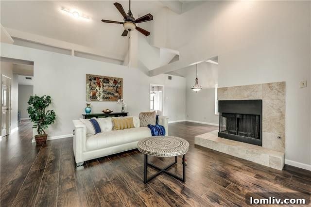 Bright and flowing living room interior with views into dining and family rooms at 806 Fawn Valley Drive, Allen