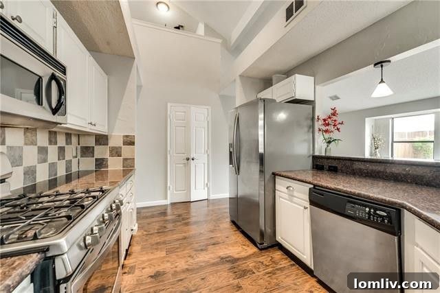 Modern kitchen featuring freshly painted cabinets, granite countertops, tile backsplash, and stainless steel appliances at 806 Fawn Valley Drive