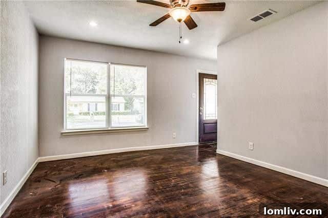 Refinished hardwood floors and fresh paint in a bedroom at 8232 Rayville Drive Dallas