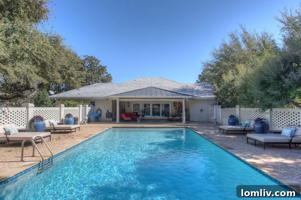 Private pool and recently updated cabana surrounded by mature oak trees, offering a serene retreat.