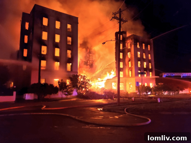 Dallas' historic Ambassador Hotel engulfed in a four-alarm fire, casting a glow over the city in the early hours.