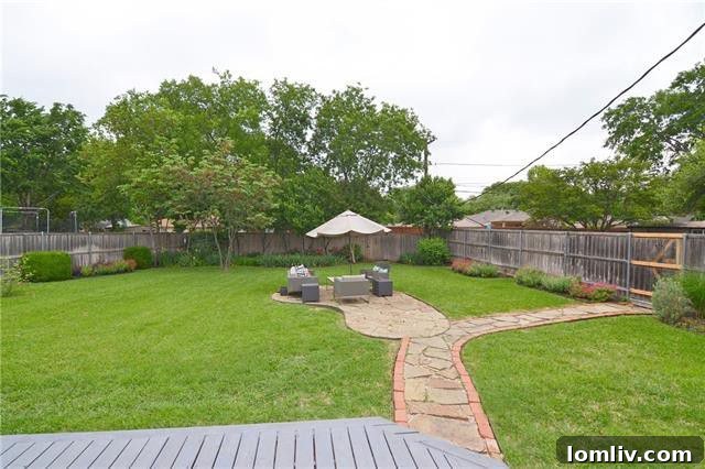 Large fenced backyard with mature trees, offering privacy and space