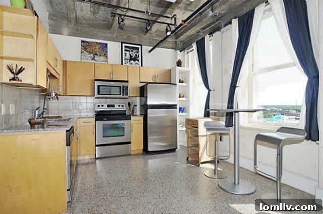 Bedroom view inside a Texas & Pacific Loft, featuring large windows and an open, airy feel.