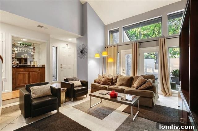 Spacious sunken living room at 9646 Baseline Drive with a floor-to-ceiling fireplace, arched ceilings, and ample natural light.
