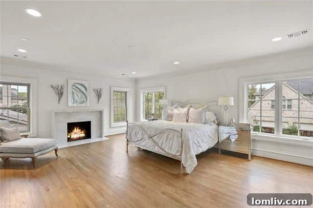 Luxurious master suite with elegant bedding and ample natural light