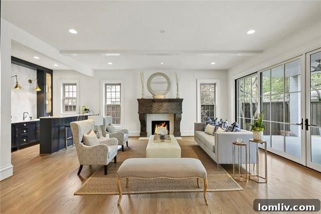 Luxurious living space featuring a hand-carved marble fireplace and elegant furnishings