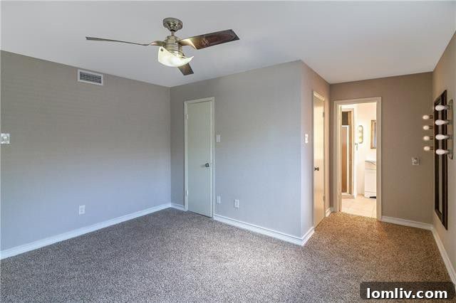 Spacious bedroom with ample closet space and access to a private, updated bathroom