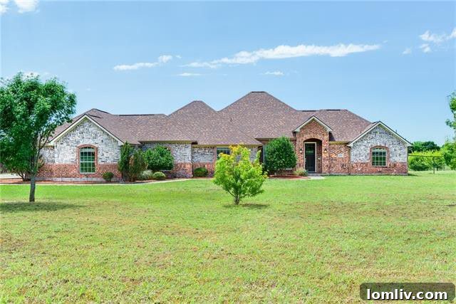 Contemporary country home with a well-maintained lawn and inviting entrance