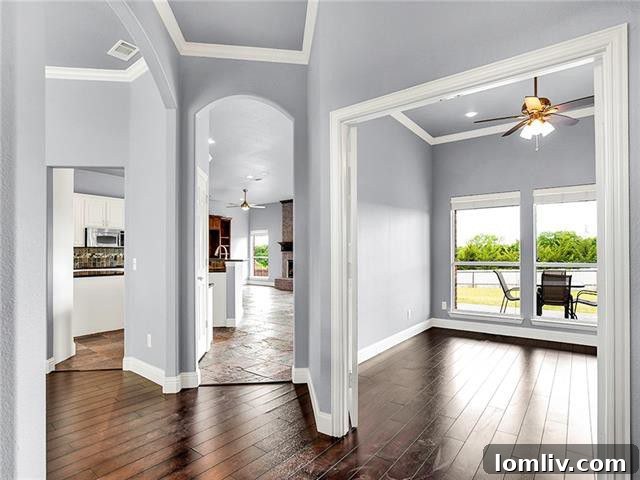 Open concept living room with a cozy brick fireplace and built-in entertainment center