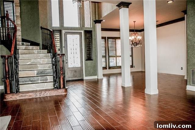 Elegant living area with stone fireplace and hardwood floors in a Princeton Lakes home