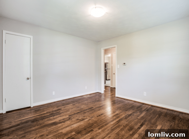 Cozy bedroom with ample natural light and hardwood floors in a renovated North Oak Cliff home