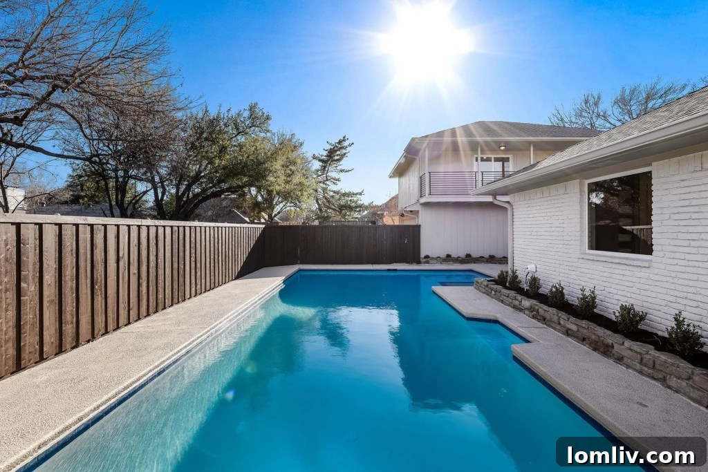 Serene outdoor patio area with lush landscaping and ample space for relaxation