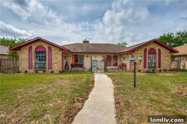 Spacious living room featuring vaulted ceilings, a brick fireplace, and ample natural light