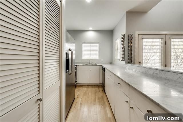 Bright and airy living area of an Uptown condo boasting high ceilings and elegant wood floors