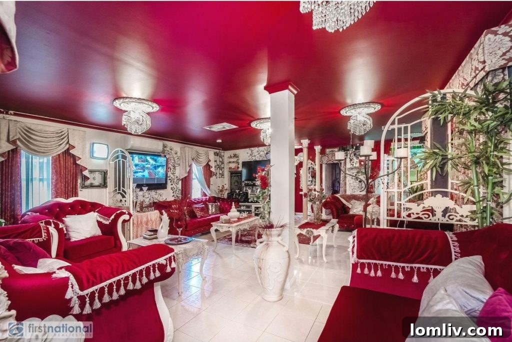 Another perspective of the lavish living room, featuring more red upholstery and decorative golden elements.