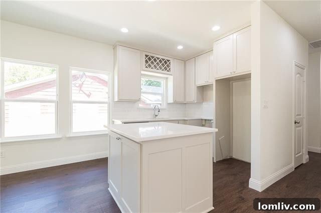 Bright white kitchen with quartz counters in East Oak Cliff home
