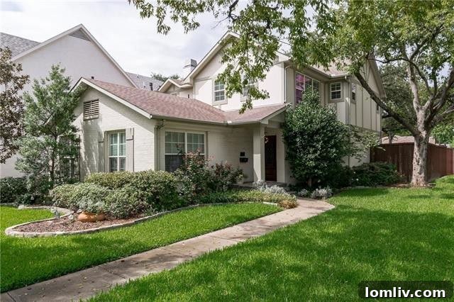 Expansive backyard with limestone patio and mature oak tree in a Devonshire home