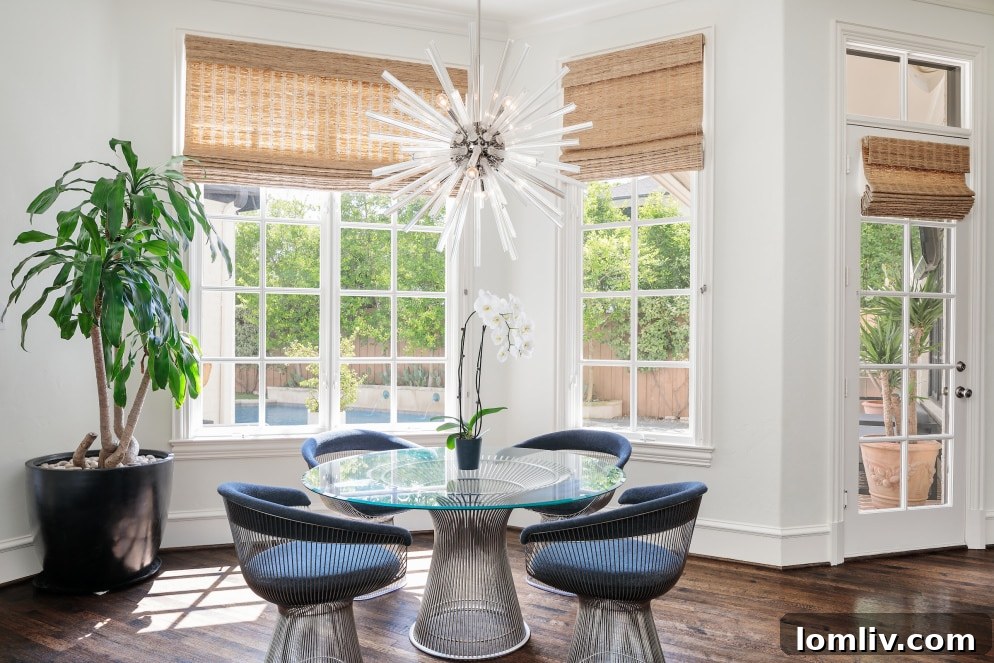 Modern kitchen island and dining area in the renovated English Cotswold manor